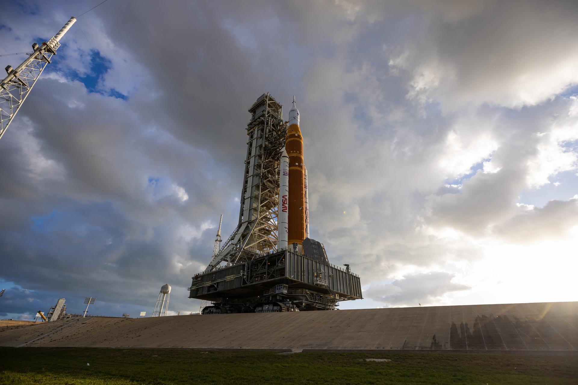 This image shows NASA’s SLS (Space Launch System) and Orion spacecraft rolling out of the Vehicle Assembly Building at NASA’s Kennedy Space Center. NASA's massive Crawler-Transporter, upgraded for the Artemis program, carries the powerful SLS rocket and Orion spacecraft on the Mobile Launcher from the Vehicle Assembly Building to Launch Pad 39B at Kennedy Space Center in preparation for the Artemis II mission.
